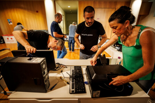 Membro da Recycle Geeks a supervisionar a reparação de computadores durante sessão de capacitação na UPTEC